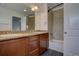 Bathroom boasts a dual-sink vanity, granite countertops, and tiled shower over tub at 9520 Halstead, Lone Tree, CO 80124