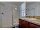 Bathroom with a glass enclosed shower, granite countertop, and dark wood cabinets at 9520 Halstead, Lone Tree, CO 80124