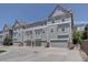Modern townhouse with light gray siding and gray garage doors at 9520 Halstead, Lone Tree, CO 80124