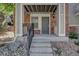 Inviting front entrance with a well-lit porch and concrete steps at 9520 Halstead, Lone Tree, CO 80124