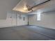 Spacious garage with painted floor, white walls, and white door to the interior of the home at 9520 Halstead, Lone Tree, CO 80124