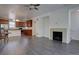 Open-concept living room flows seamlessly to a kitchen and features a fireplace adding warmth to the space at 9520 Halstead, Lone Tree, CO 80124