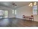 Bright living room featuring hardwood floors, ceiling fan, natural light from sliding glass door and table seating two at 9520 Halstead, Lone Tree, CO 80124
