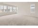 Large bedroom with neutral carpet and big windows providing lots of natural light at 7308 Waterleaf Trl, Littleton, CO 80125