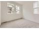 Well-lit bedroom with neutral carpet, large windows, and an inviting atmosphere at 7308 Waterleaf Trl, Littleton, CO 80125