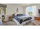 Cozy bedroom with a comfy bed, soft carpet, and natural light streaming through the large window at 8481 W Union Ave # 13203, Denver, CO 80123