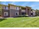 Inviting condo complex featuring manicured lawn, brick accents, and a neutral color palette at 8481 W Union Ave # 13203, Denver, CO 80123