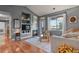 Cozy living room with hardwood floors, a fireplace, built-in shelving, and a sliding glass door at 8481 W Union Ave # 13203, Denver, CO 80123