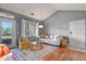 Comfortable living room featuring a vaulted ceiling, hardwood floors, and ample natural light at 8481 W Union Ave # 13203, Denver, CO 80123