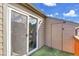 A back porch features a sliding glass door, storage, and faux grass for easy maintenance at 17478 E Rice Cir # D, Aurora, CO 80015