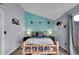 Comfortable bedroom with rustic wood frame bed and blue accent wall with western themed decorations at 17478 E Rice Cir # D, Aurora, CO 80015
