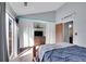 Bright bedroom with vaulted ceiling, sliding doors and a decorative shelf featuring a television at 17478 E Rice Cir # D, Aurora, CO 80015