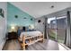 Charming bedroom features a unique log bed frame and a sliding glass door leading to a private outdoor area at 17478 E Rice Cir # D, Aurora, CO 80015