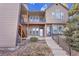 Inviting two-story townhome featuring a cozy balcony, a welcoming entrance, and traditional architectural charm at 17478 E Rice Cir # D, Aurora, CO 80015