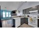 Charming kitchen with a dishwasher, oven, and cabinets visible from the living area at 17478 E Rice Cir # D, Aurora, CO 80015