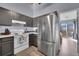 Well-equipped kitchen with stainless steel refrigerator and contemporary countertops and cabinets at 17478 E Rice Cir # D, Aurora, CO 80015
