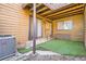 Cozy backyard area with artificial turf, wooden siding, and sliding glass door access at 9088 W 88Th Cir, Westminster, CO 80021