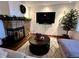Cozy living room featuring a stone fireplace, hardwood floors, and modern decor at 9088 W 88Th Cir, Westminster, CO 80021