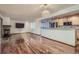 Inviting living area with a breakfast bar, hardwood floors, and an open view to the kitchen at 9088 W 88Th Cir, Westminster, CO 80021