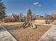 Community playground area with slide, steps, and play area, surrounded by residential buildings and a basketball court at 9088 W 88Th Cir, Westminster, CO 80021