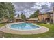 Community pool surrounded by trees, with covered seating, surrounded by residences in the background on a cloudy day at 9088 W 88Th Cir, Westminster, CO 80021