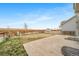 Expansive backyard with a concrete patio, mature tree, and wooden fence, perfect for outdoor relaxation at 18039 E 108Th Pl, Commerce City, CO 80022