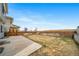 Large backyard with a concrete patio and a well-maintained wooden fence, perfect for outdoor activities at 18039 E 108Th Pl, Commerce City, CO 80022