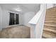 Basement featuring neutral carpet, a window, and stairs, offering potential for versatile use at 18039 E 108Th Pl, Commerce City, CO 80022