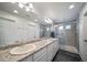 Spacious bathroom featuring dual sinks, generous countertop space, and a glass-enclosed shower for a spa-like experience at 18039 E 108Th Pl, Commerce City, CO 80022