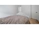 This bedroom features an open door, neutral carpet, and a queen bed, creating a peaceful space at 18039 E 108Th Pl, Commerce City, CO 80022