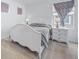 This bedroom features a queen bed, side tables with lamps, and a window, creating a welcoming atmosphere at 18039 E 108Th Pl, Commerce City, CO 80022