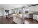Open layout showcasing kitchen with granite island adjacent to living room and views to a modern fireplace at 18039 E 108Th Pl, Commerce City, CO 80022