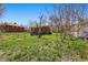 Quaint brick home with a spacious backyard under a clear blue sky, presenting outdoor potential at 1914 Washington Ave, Golden, CO 80401