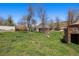 View of accessory building from a verdant backyard with mature trees, and blue sky above at 1914 Washington Ave, Golden, CO 80401