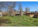 Scenic backyard of brick home featuring mature trees, lush greenery, and a clear blue sky at 1914 Washington Ave, Golden, CO 80401