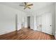 Bright bedroom with hardwood floors, white walls, and multiple doorways, offering versatile living space at 1914 Washington Ave, Golden, CO 80401