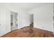 Bright bedroom with hardwood floors, white walls, and multiple doorways, offering versatile living space at 1914 Washington Ave, Golden, CO 80401