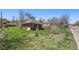Charming brick house nestled within a grassy landscape, awaiting a loving touch to restore its former glory at 1914 Washington Ave, Golden, CO 80401