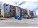 Multi-story condo building featuring private balconies and ample parking with a mountain view in the background at 8666 Decatur St # 254, Westminster, CO 80031