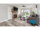 Cozy living room features a stone fireplace, a ceiling fan, and a sliding glass door to the balcony at 8666 Decatur St # 254, Westminster, CO 80031