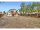 Spacious backyard with a wooden fence and second story deck at 825 S Quitman St, Denver, CO 80219