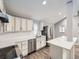 Bright kitchen with white cabinets, quartz countertops, and stainless steel appliances at 825 S Quitman St, Denver, CO 80219