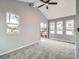 Large living room with new carpet, vaulted ceilings, and multiple windows at 825 S Quitman St, Denver, CO 80219