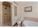 Well-lit bathroom featuring a glass shower, jacuzzi tub, and tiled flooring at 493 Cr 672, Breckenridge, CO 80424