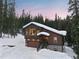 Charming mountain home with snow-covered roof and beautiful wooded surroundings at 493 Cr 672, Breckenridge, CO 80424