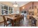 Open-concept kitchen and dining area with hardwood floors, natural light, and seating for eight at 493 Cr 672, Breckenridge, CO 80424