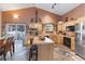 Charming kitchen featuring wooden cabinets, an island with seating, and views of the snowy outdoors at 493 Cr 672, Breckenridge, CO 80424