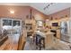 Charming kitchen featuring wooden cabinets, an island with seating, and views of the snowy outdoors at 493 Cr 672, Breckenridge, CO 80424