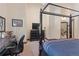 Well-lit main bedroom featuring a four-poster bed, desk space, and neutral carpet at 493 Cr 672, Breckenridge, CO 80424