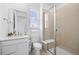 Bright bathroom features a glass shower and white vanity with a stacked towel set at 938 Hearteye Trl, Lafayette, CO 80026